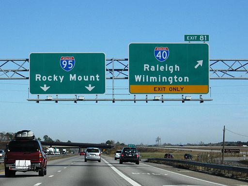 Photograph of the I-40 and I-95 interchange near Benson, N.C. A view of the free with cars scattered on the road.